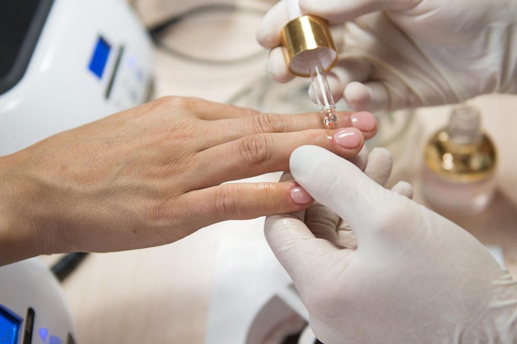 Woman having manicure applied to her hands