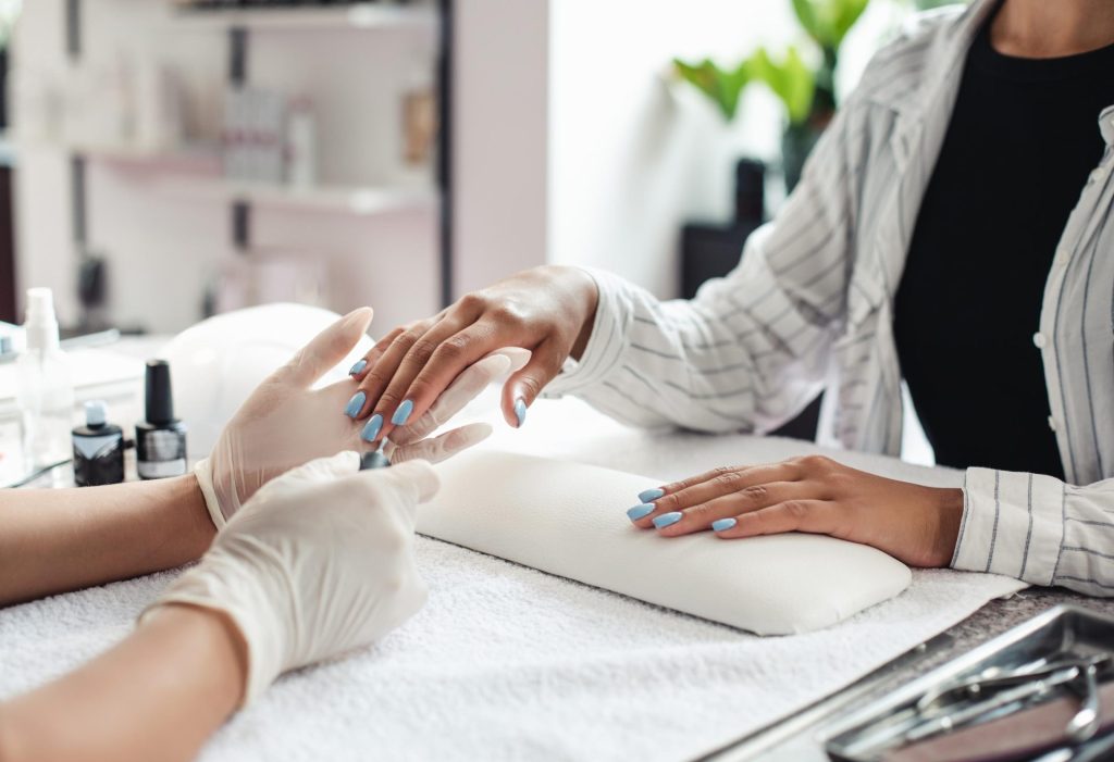 Woman having manicure applied to her hands